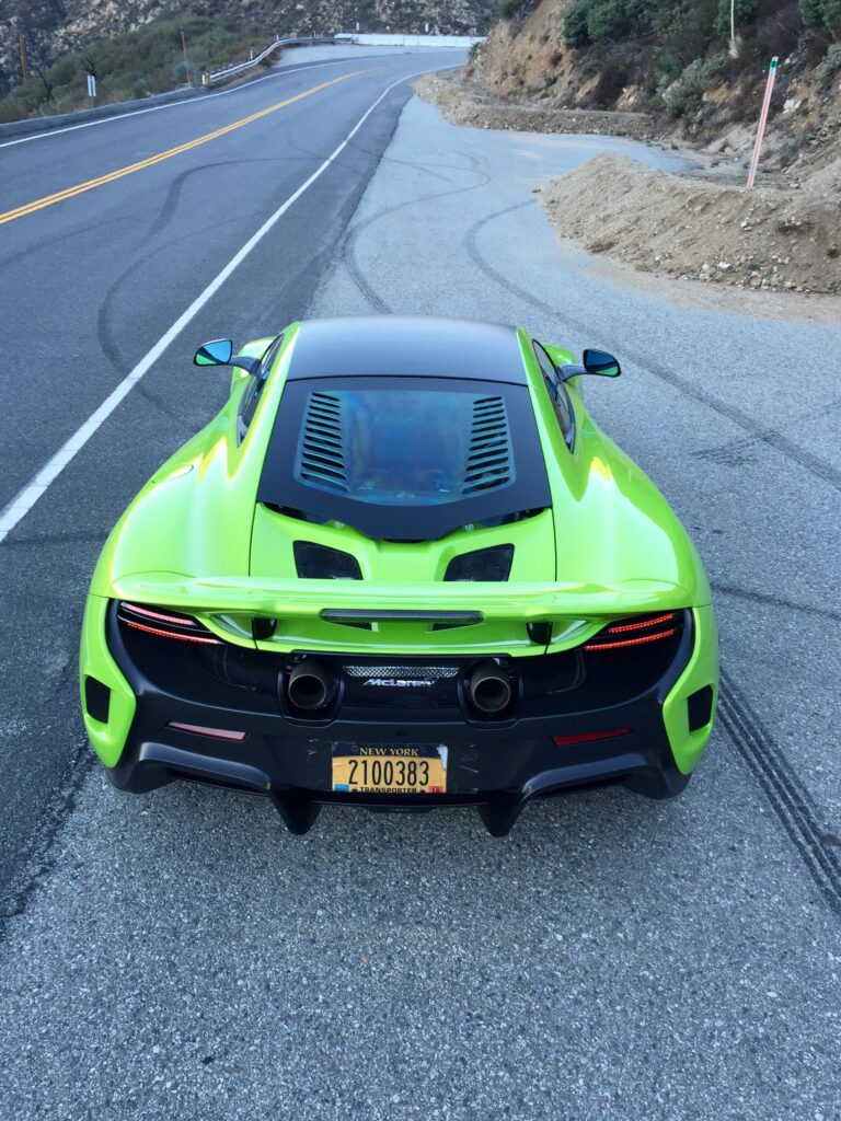  The rear paddle (the spoiler) is like the hand of God when it rises under braking. You feel its effects in the pit of your stomach. It’s real, it’s effective, and it takes up the rearview mirror when it rises. Real drama. 