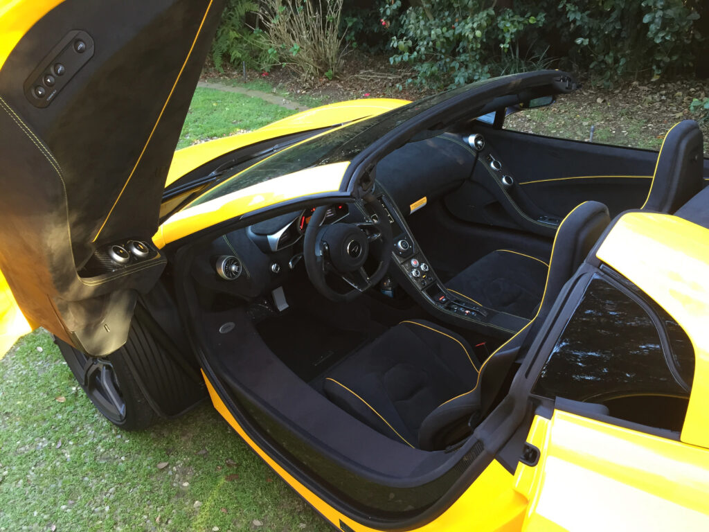 Interior in early McLarens was cramped for taller people. Over time, they gained an inch here and an inch there, making the later cars comfortable for people over six foot tall. In this early car, pre-570S, note the extreme height of the door sill. 