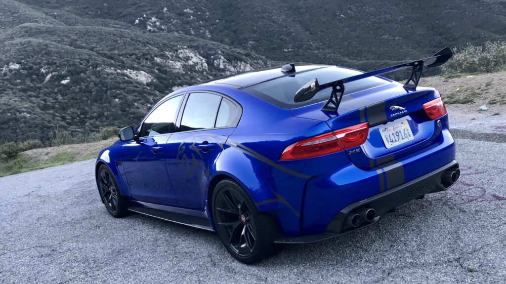 Much of the bodywork is composite. It is also very much aerodynamic. Note the diffuser and high-mounted rear wing. Jaguar doesn’t provide a lot of data on the car, and thus one can only guess the rear track is several inches wider than the standard XE. The bold and curvy wheel arches are a joy to behold.