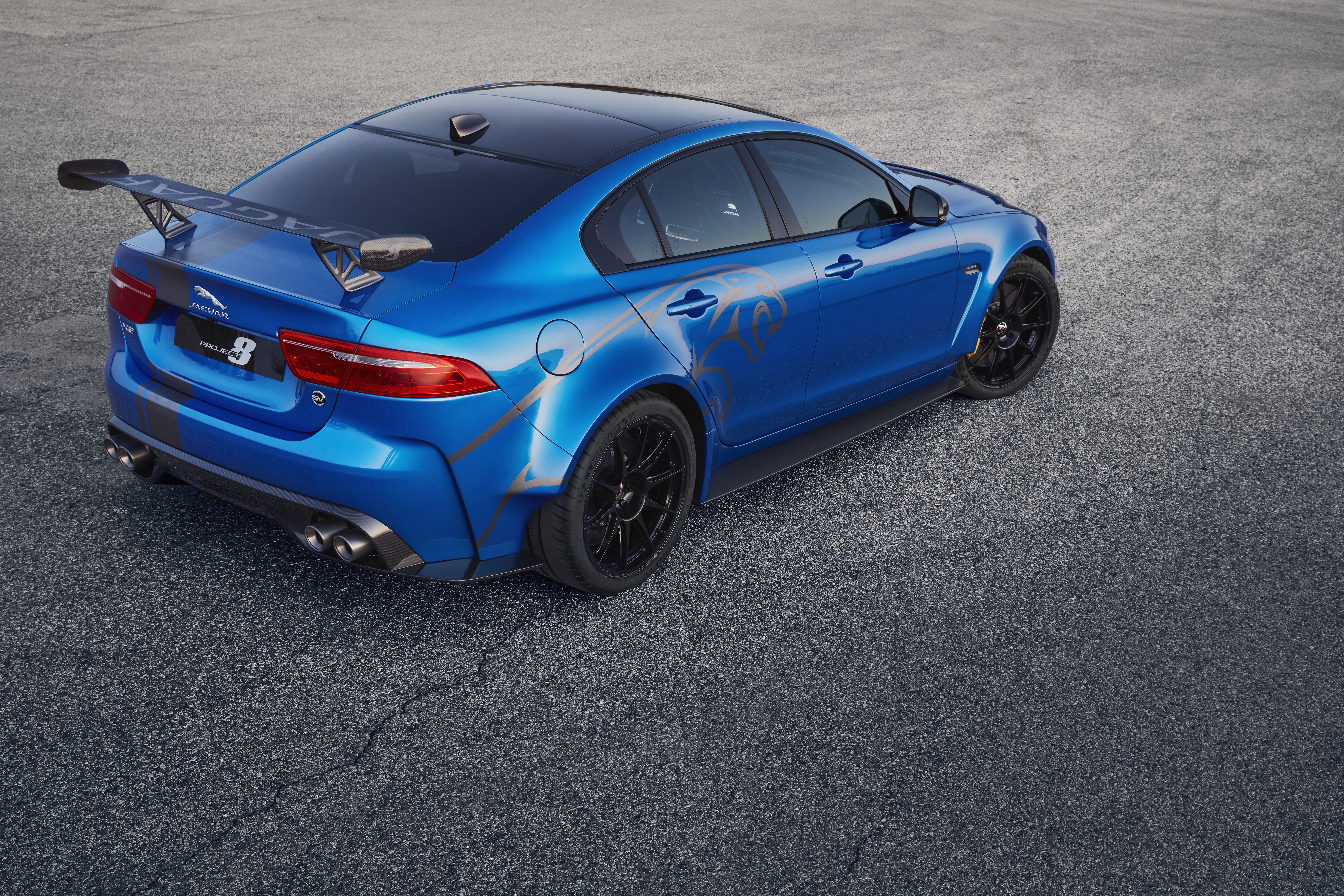 Forsake the graphic appliqués and lower the boy racer quotient about 1000 percent. The huge rear wing, pronounced and curvy rear arches, and carbon-fiber front splitter make enough statement. No one needs a leaping Jaguar on the rear doors. 
