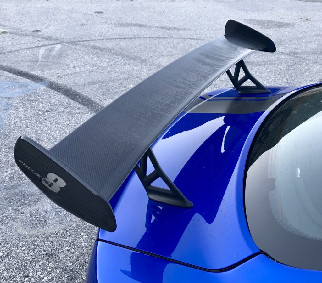 The rear wing is like a Porsche GT3 RS wing, and not as hugely proportioned as on a NISMO GT-R. The car is engineered for 200 mph, and thus the wing is necessary if a straight or airport runway long enough is stumbled across. It can be manually adjusted to two angles of attack. 